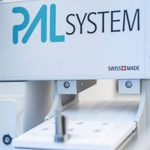 Close-up of PAL System laboratory equipment showing precision components and Swiss Made branding for automated sample handling.